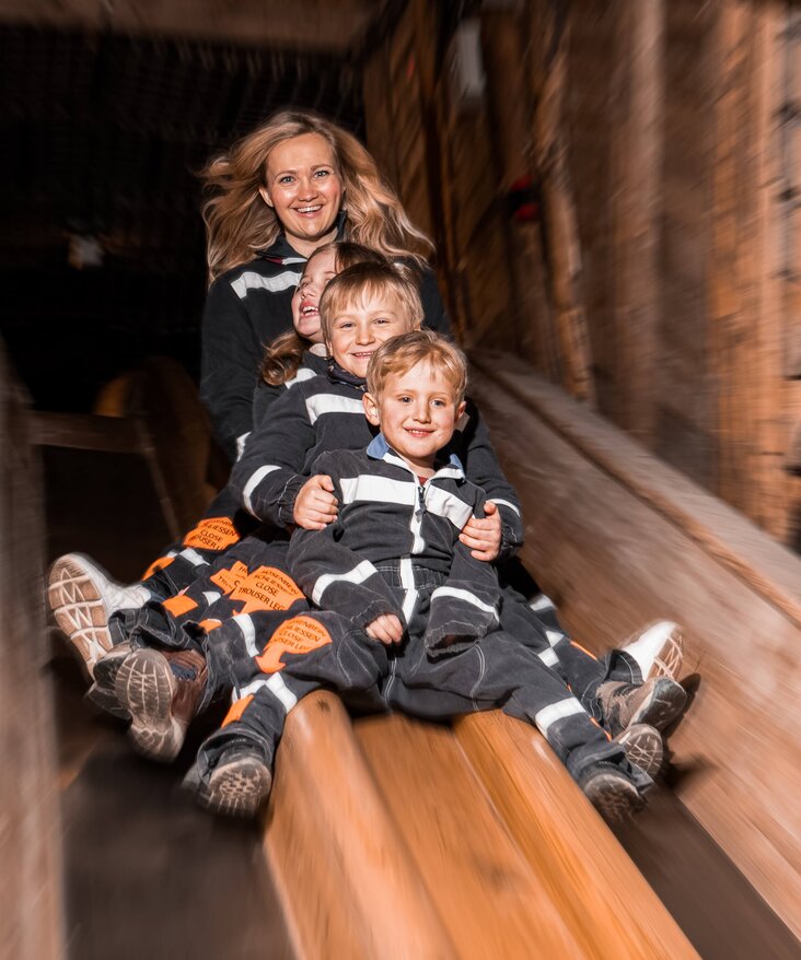 Mother with children on the slide to the Spiegelsee lake