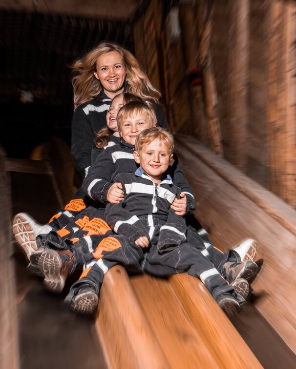 Mother with children on the slide to the Spiegelsee lake