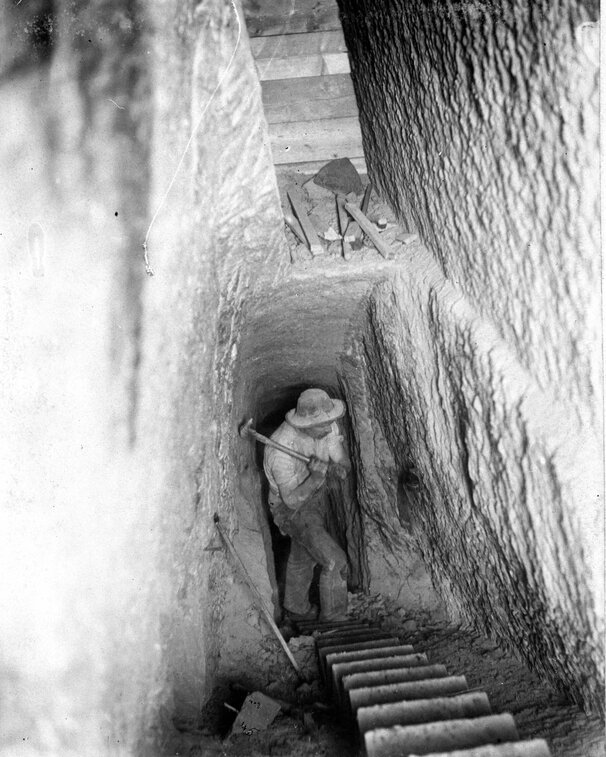 Miners in a narrow mine passage