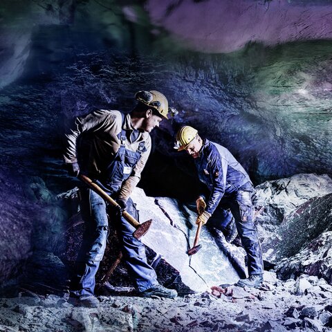 Miners mining salt underground