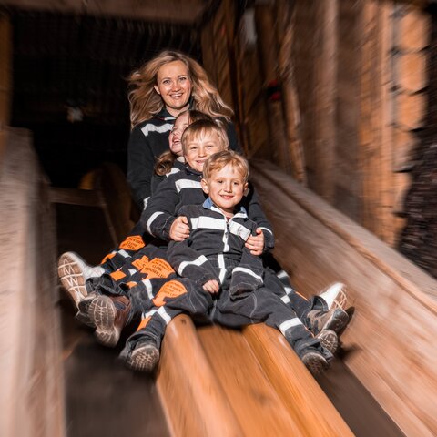 Mother with children on the slide to the Spiegelsee lake