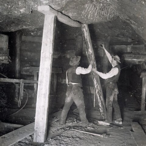 Two miners underground in the olden days