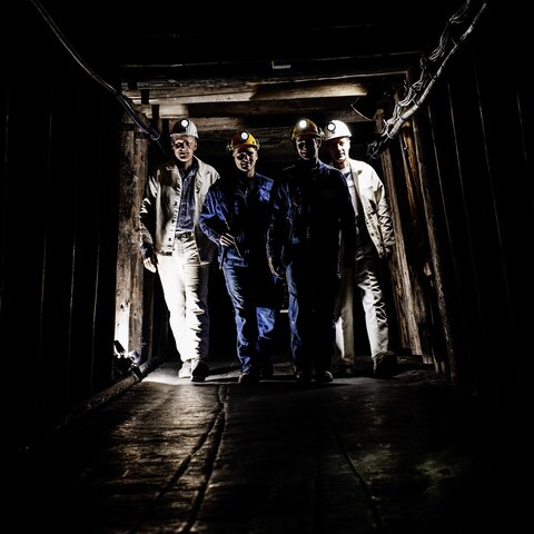 Four miners in the underground tunnel